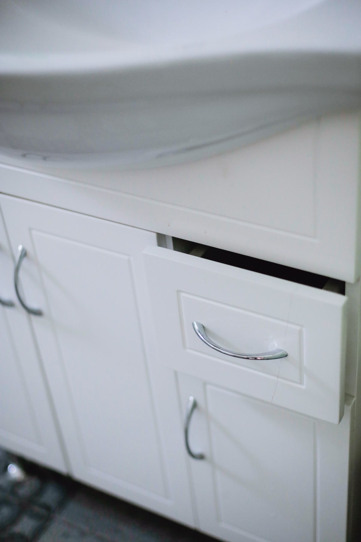 Bathroom vanity cabinet interior where water leak sensors are placed under the sink plumbing