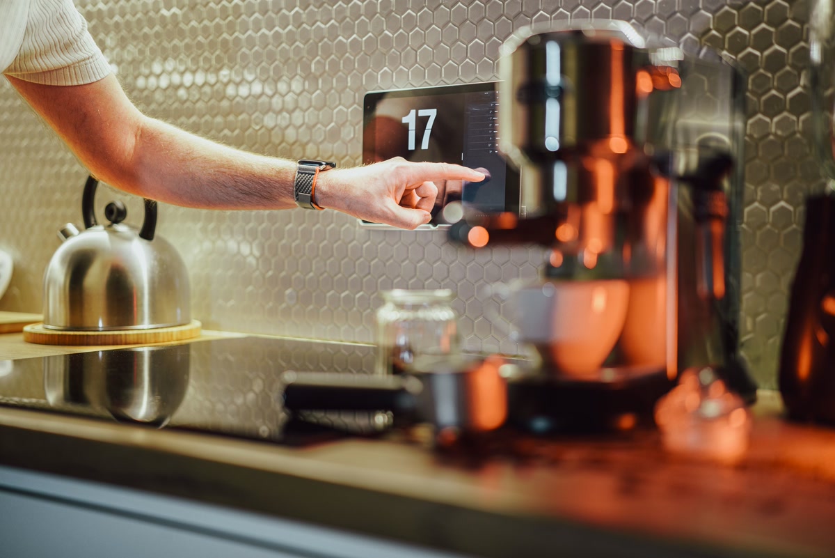 Person using touchscreen panel on a smart coffee machine