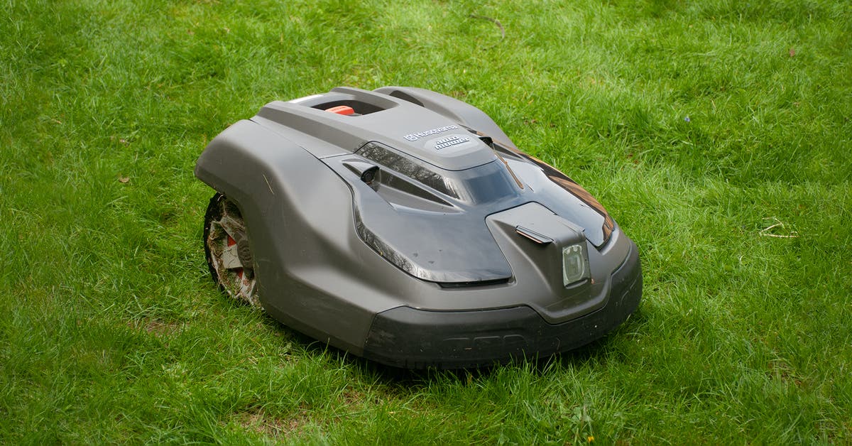 Automatic robot lawn mower cutting green grass