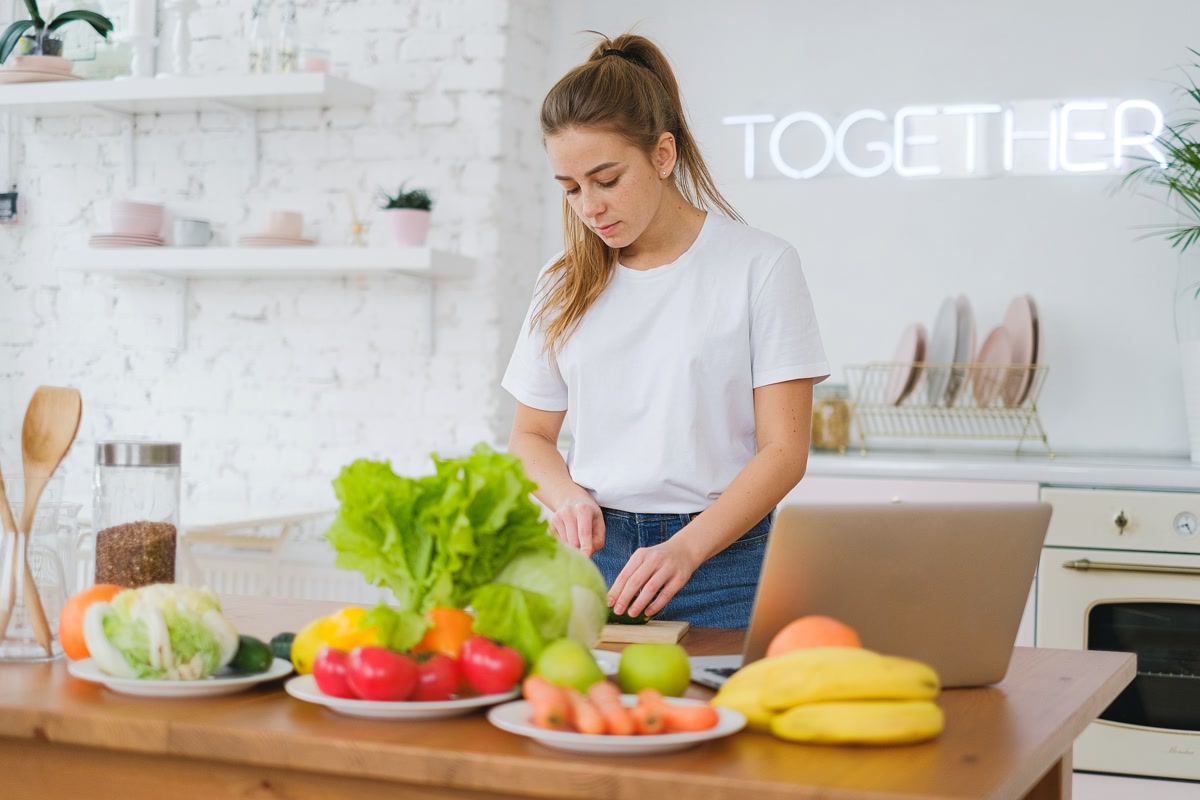 Person cooking in kitchen using voice assistant for hands-free recipes