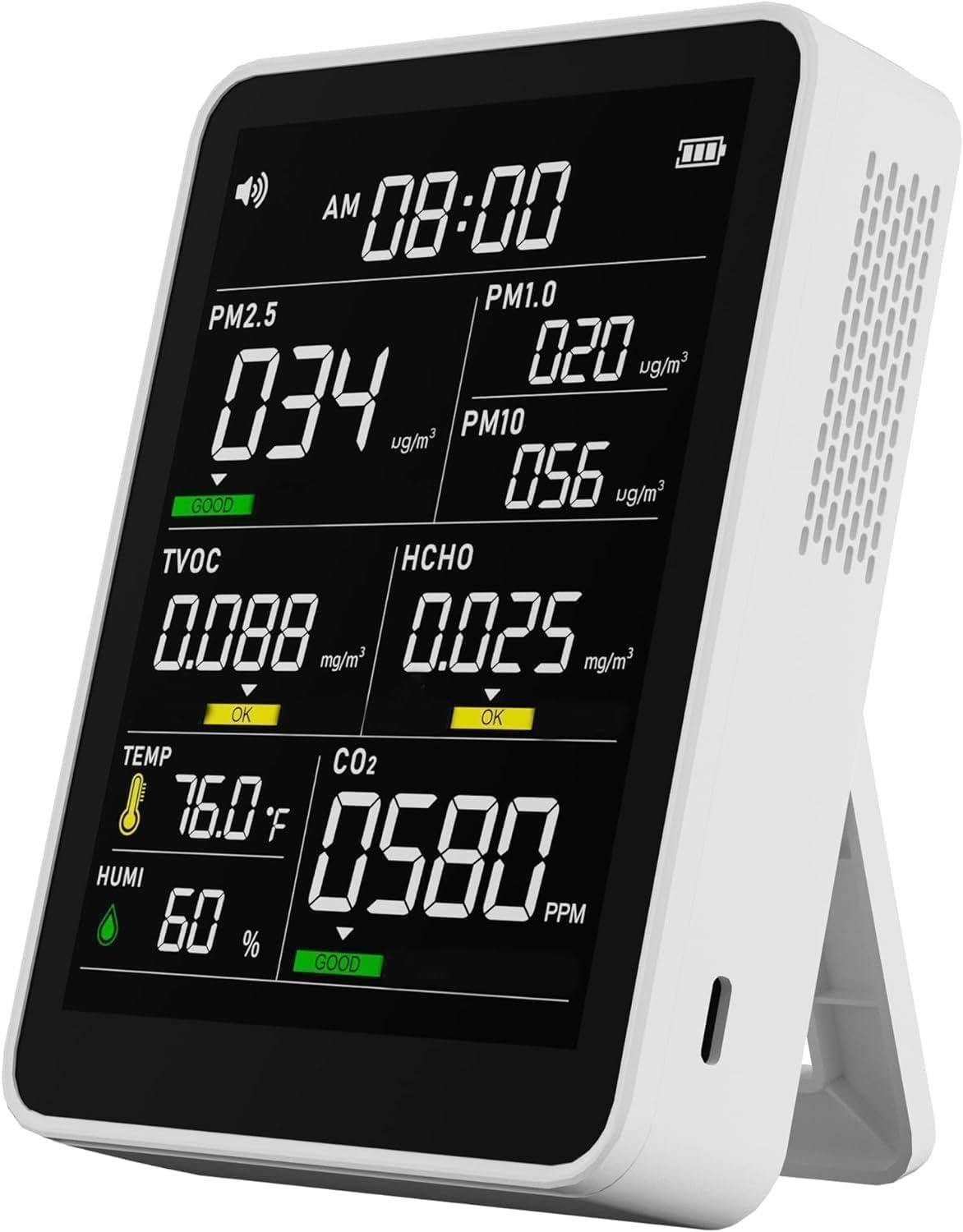 Air quality monitor device on a table in a home setting with indoor plants