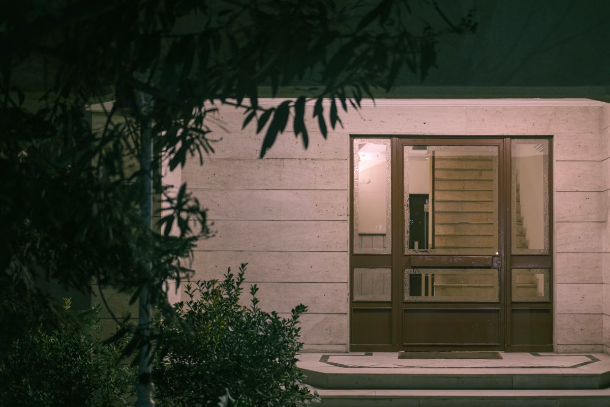 Upgraded front entrance with matching matte black smart lock and handleset at evening