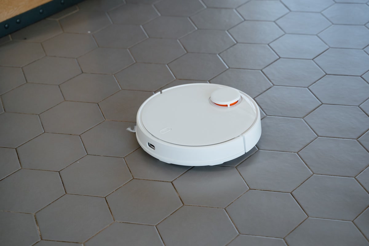 Robot vacuum with mopping function cleaning a kitchen floor