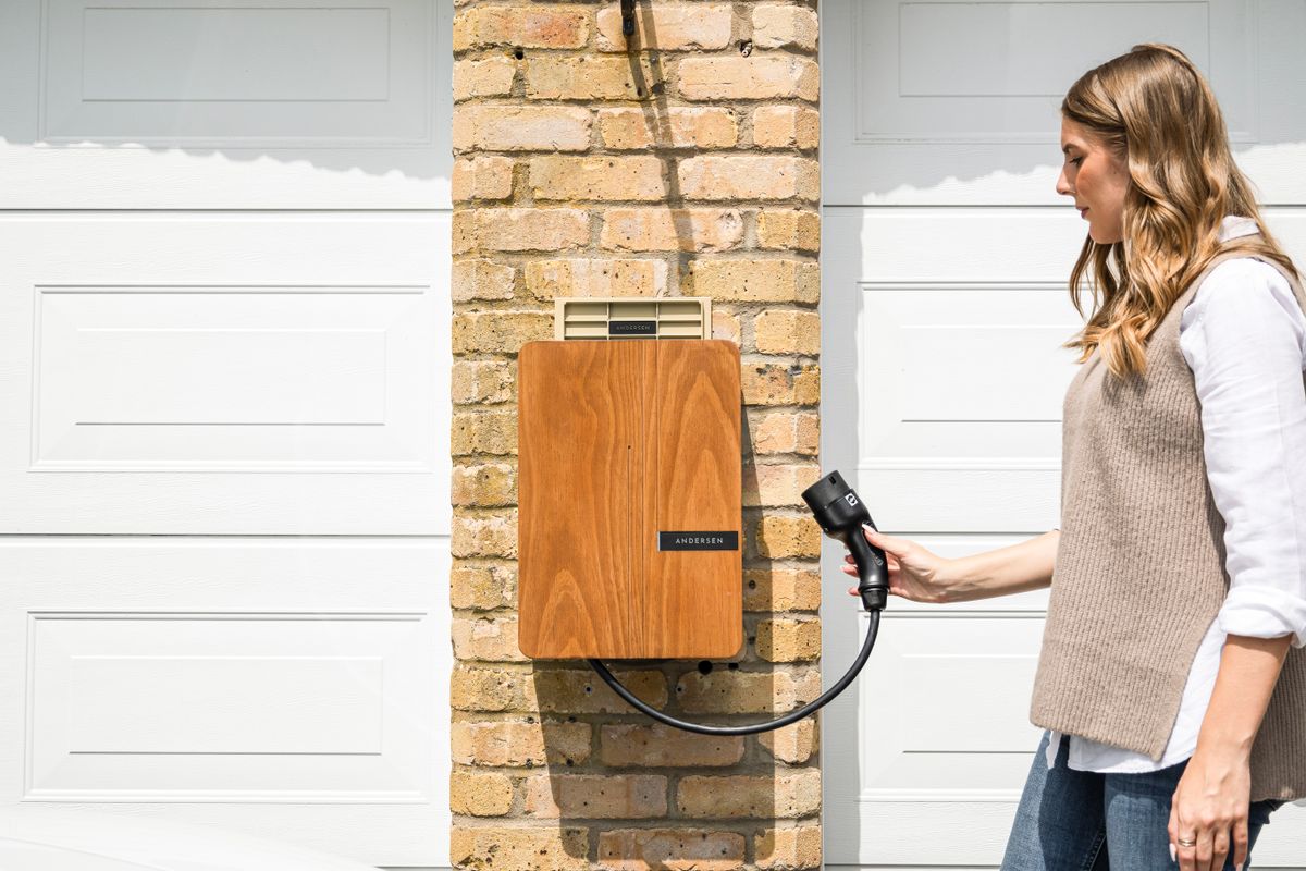 Smart EV charger mounted on garage wall with cable connected