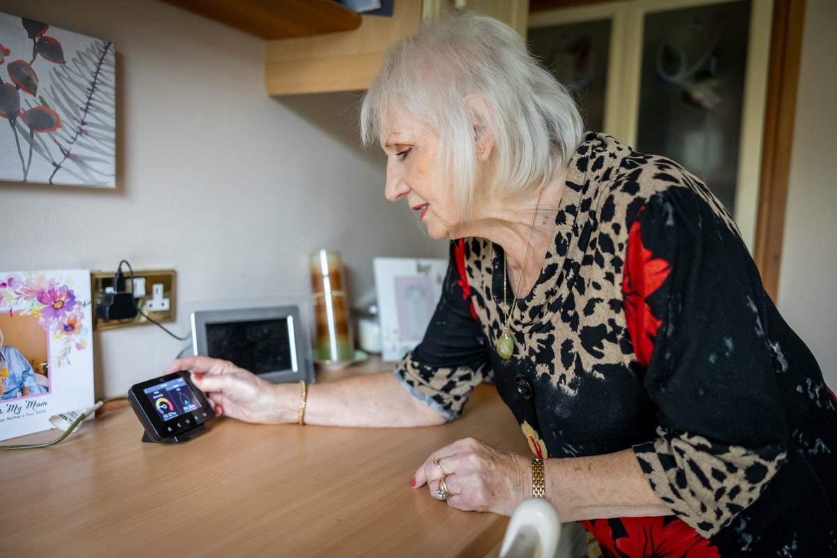 Person reviewing energy usage data on a smart home monitor