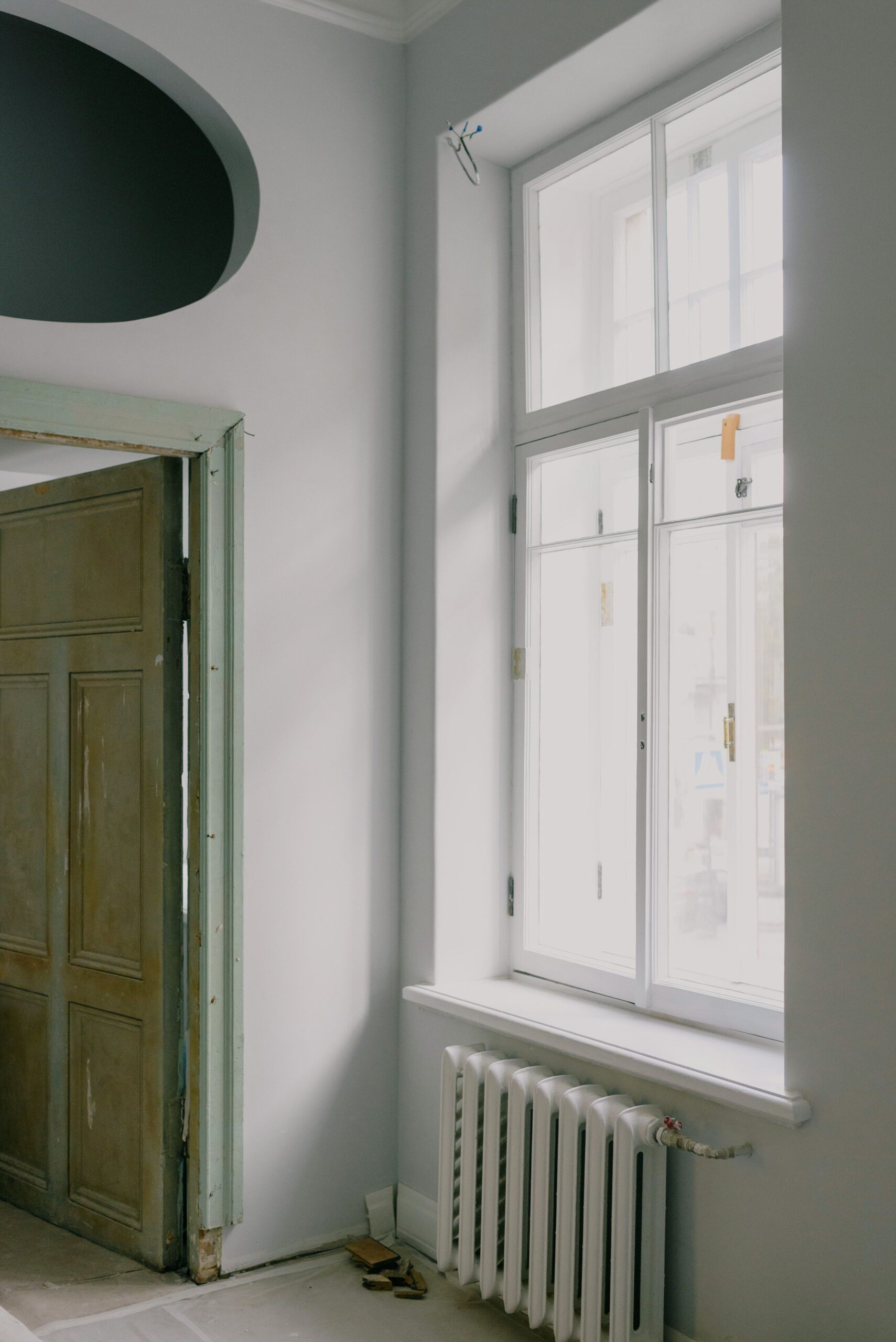 Interior of a new flat with a window and heating system near an open door