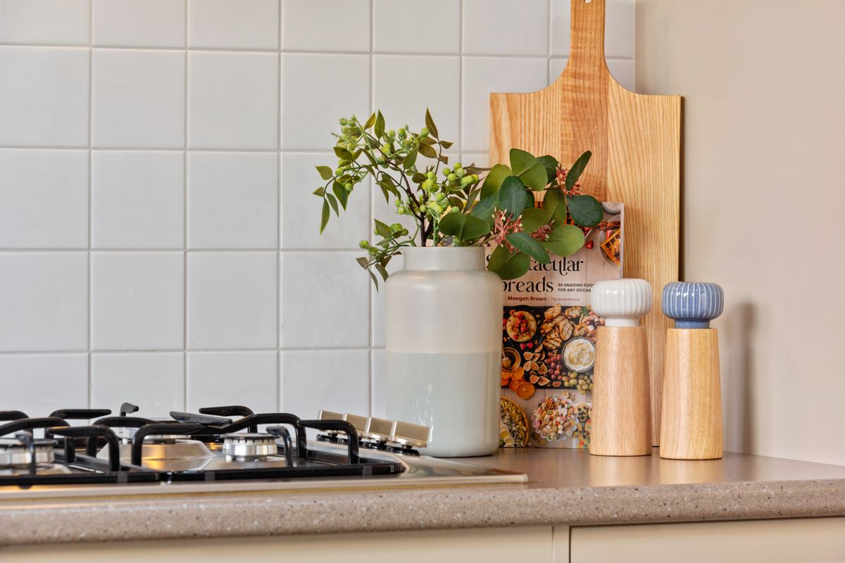 Kitchen counter with gas cooktop and white tile