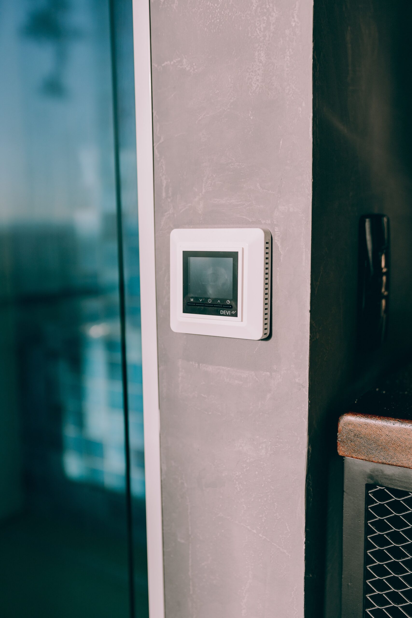 Smart thermostat mounted on a wall reflecting modern interior design