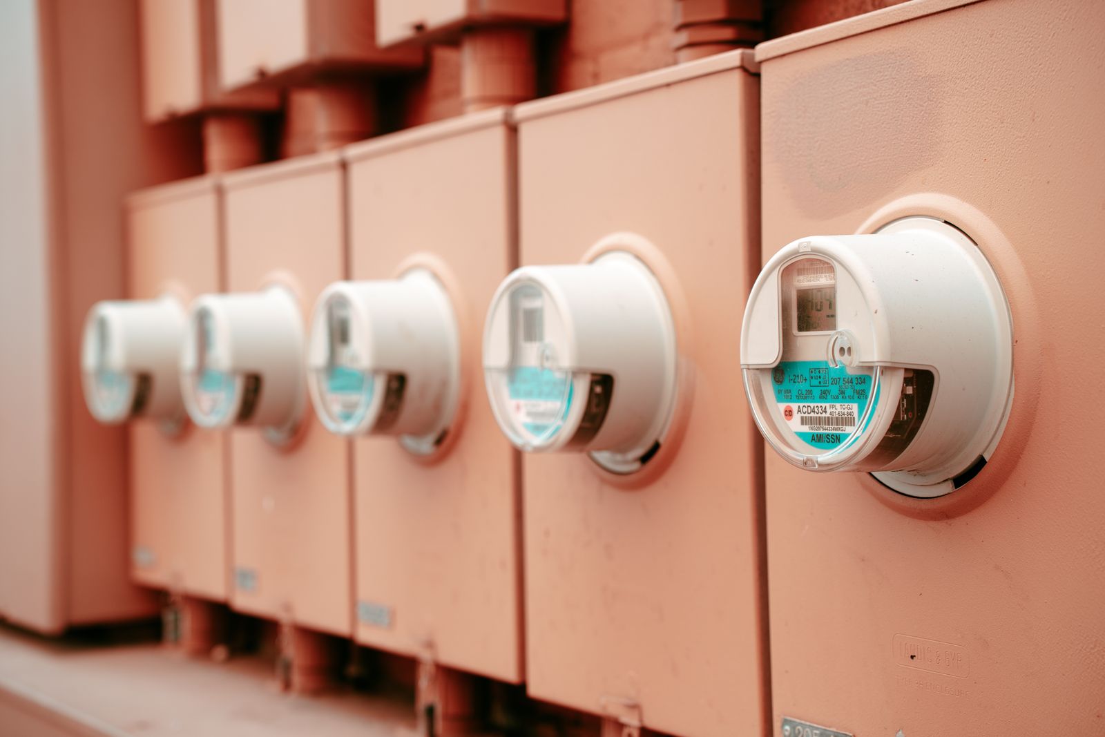 Row of round electricity meter dials on a wall