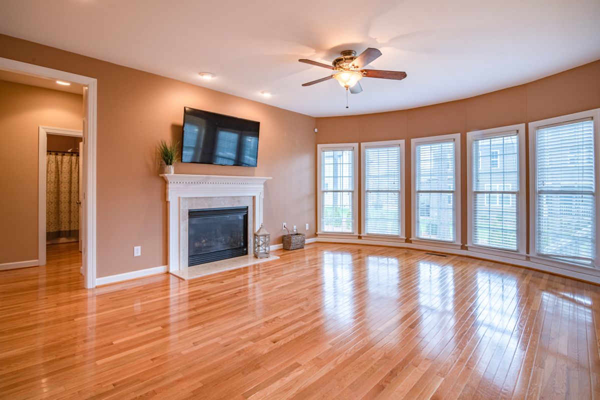 Ceiling fan in a bright living room with hardwood floors