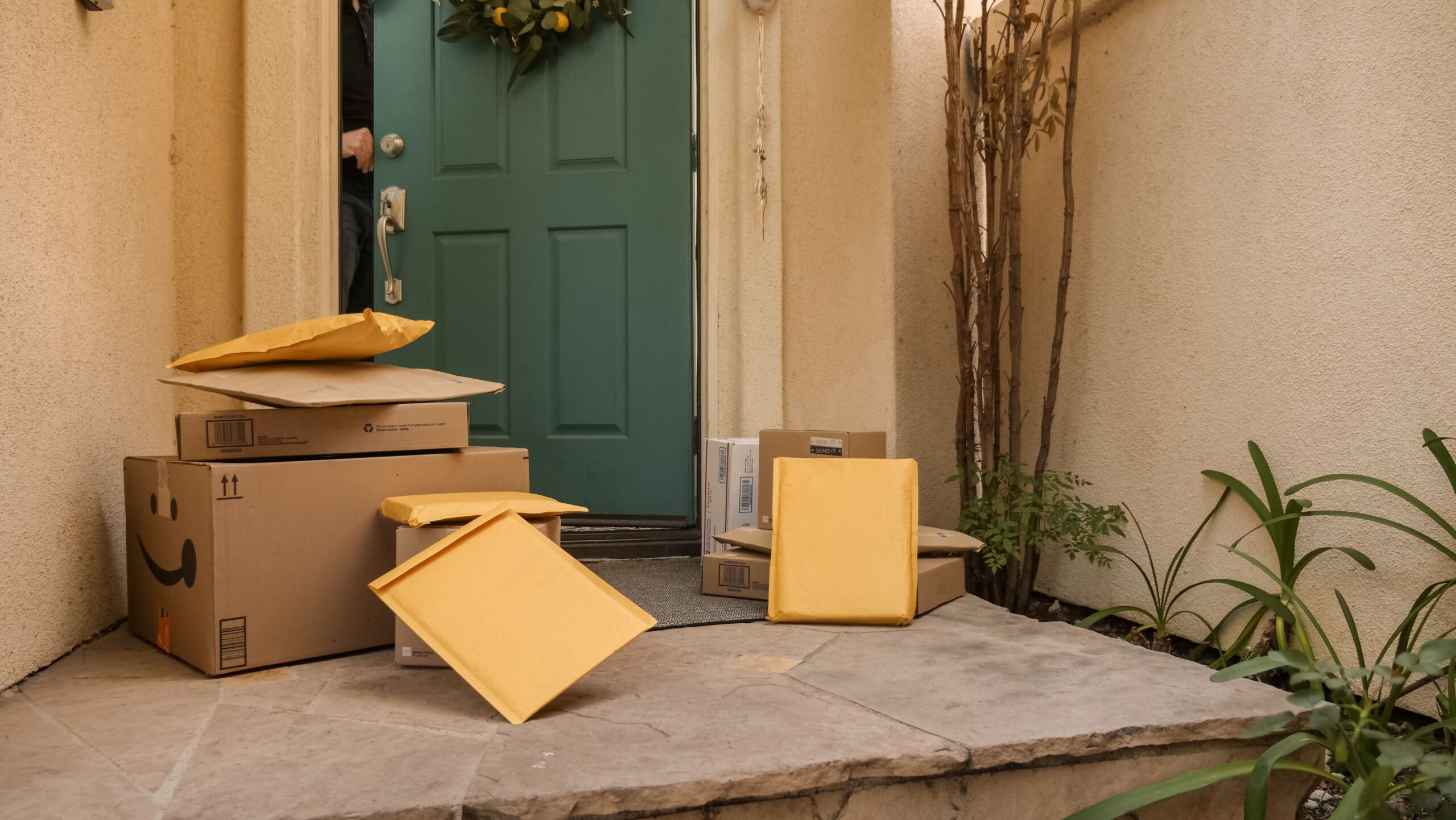 Cardboard packages stacked on a residential porch during delivery season